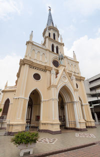 Low angle view of church and building against sky