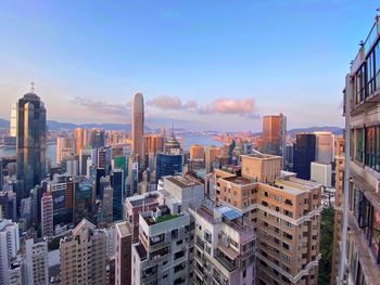 Aerial view of buildings in city against sky