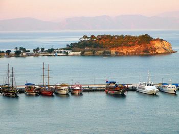 Boats moored in sea against sky