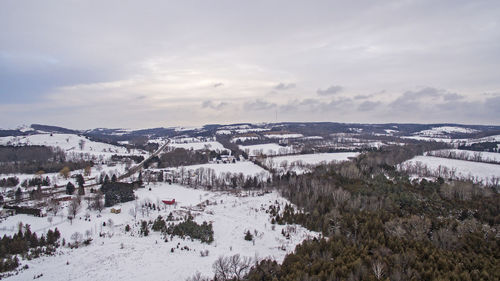 Scenic view of snow covered mountains against cloudy sky