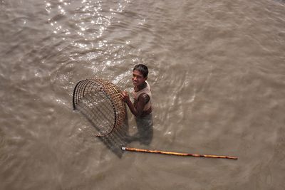 High angle view of man fishing in sea