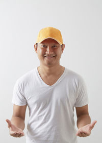 Portrait of smiling young man against white background