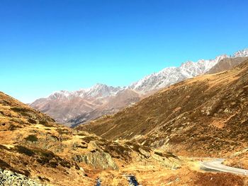 Scenic view of mountains against clear blue sky