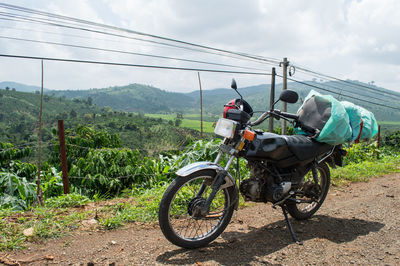 Motorcycle on field against sky