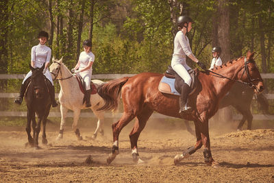 Group of people riding horse