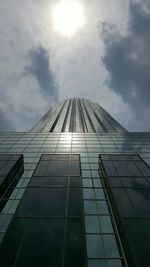 Low angle view of skyscraper against cloudy sky