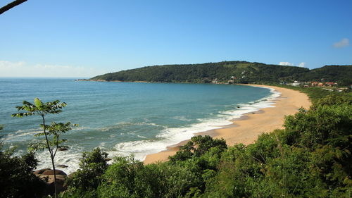 View of calm beach against blue sky