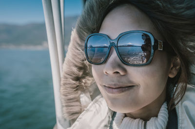 Close-up of smiling woman wearing sunglasses