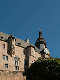 Low angle view of building against clear blue sky