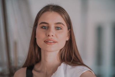 Portrait of a smiling young woman at home