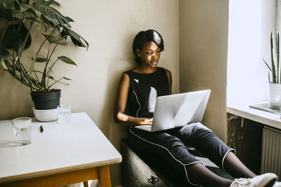 Female entrepreneur using laptop while sitting in office