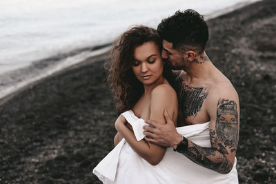 Young couple kissing on beach