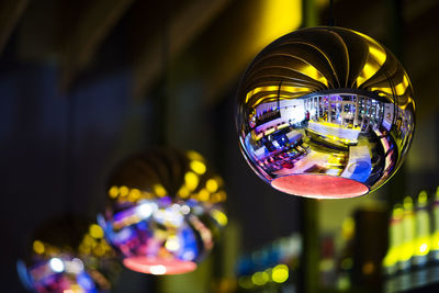 Low angle view of illuminated lighting equipment hanging in restaurant