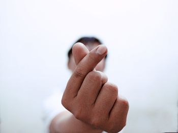 Close-up of human hand over white background