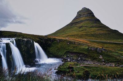 Scenic view of waterfall against sky