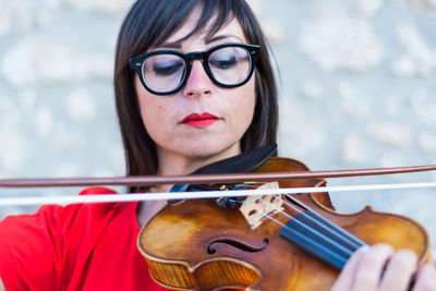 Close-up of woman playing violin