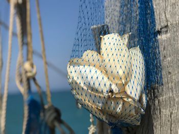 Low angle view of decoration hanging against blue sky