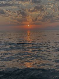 Scenic view of sea against romantic sky at sunset