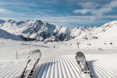 Scenic view of snow covered mountains against sky