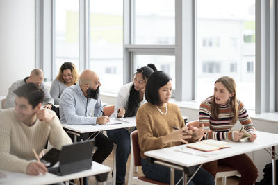 Adult students sitting in class