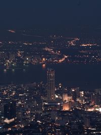 High angle view of illuminated city buildings at night