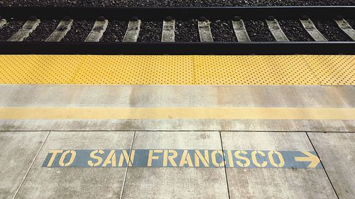 High angle view of text on railroad station platform