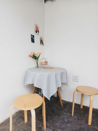 Empty chairs and table against wall at home