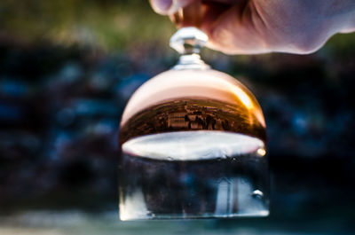 Reflection of buildings on glass bottle