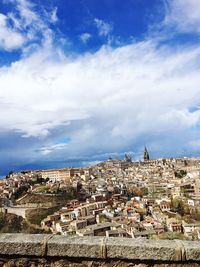 Buildings against blue sky and clouds