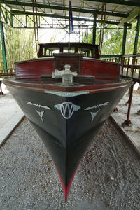 Red boat moored on table