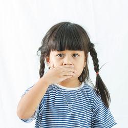 Portrait of cute girl against white background