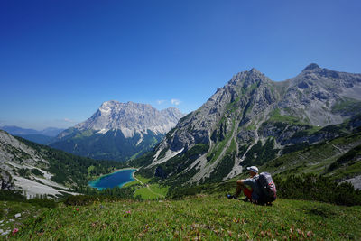 Scenic view of snowcapped mountains against blue sky