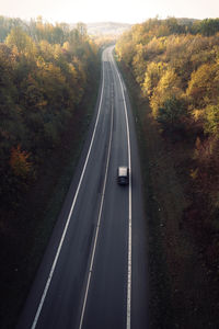 Car moving on road amidst trees