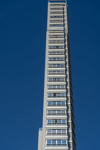 Low angle view of modern building against blue sky