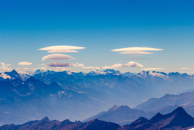 Scenic view of mountains against clear blue sky