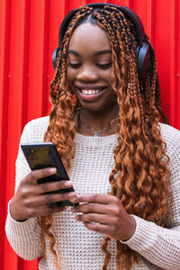 Portrait of young woman using mobile phone