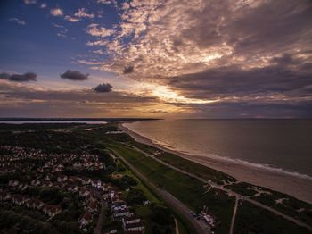 High angle view of beach against sky during sunset