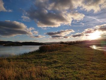 Scenic view of lake against sky during sunset