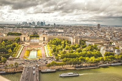 Buildings in city against cloudy sky