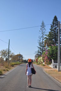 Full length of woman walking on road