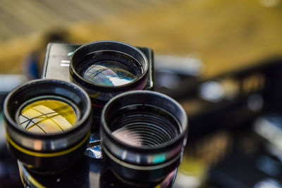 Close-up of camera lenses on table