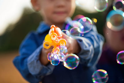 Boy playing with bubble wand