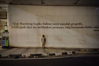 Full length of man standing on street in city