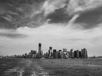 City skyline against cloudy sky