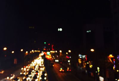 Defocused image of illuminated city at night