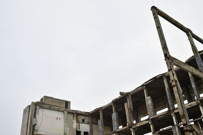 Low angle view of abandoned building against sky