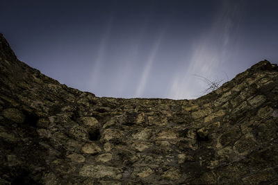 Low angle view of rock formation against sky