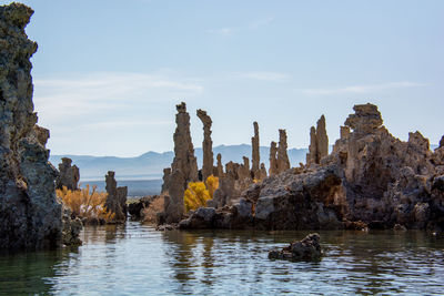 Panoramic view of rock formation amidst trees against sky