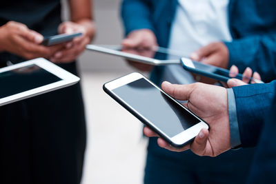 Midsection of man using mobile phone