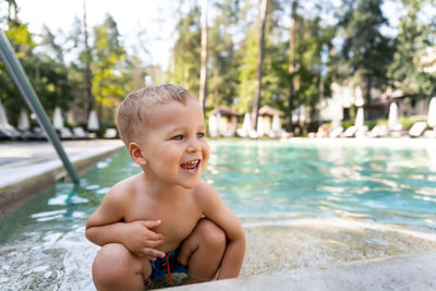 Portrait of shirtless boy in swimming pool